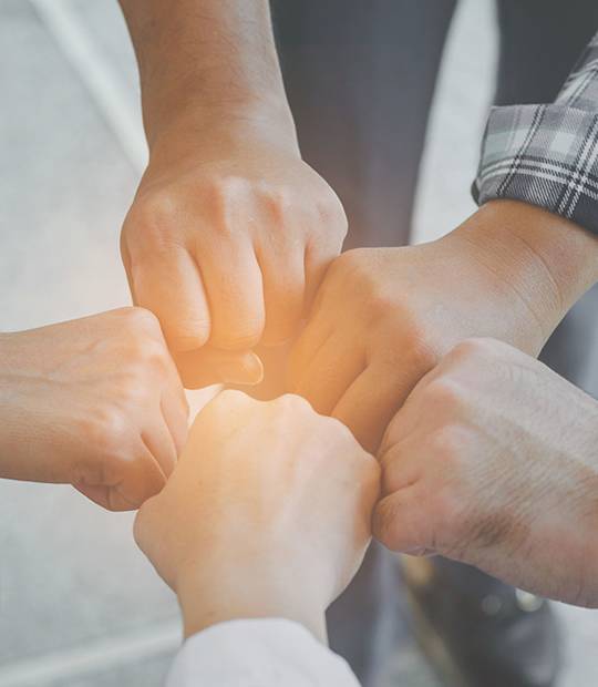 Five fists hold together to represent their determination.