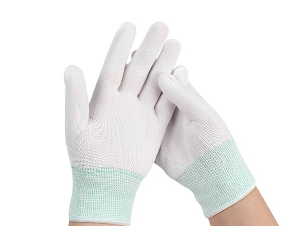 Two hands are wearing a pair of nylon knitted safety gloves.